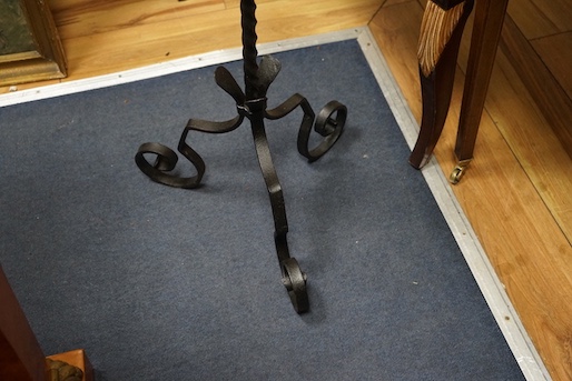 A wrought iron tripod pricket candle stand, height 140cm